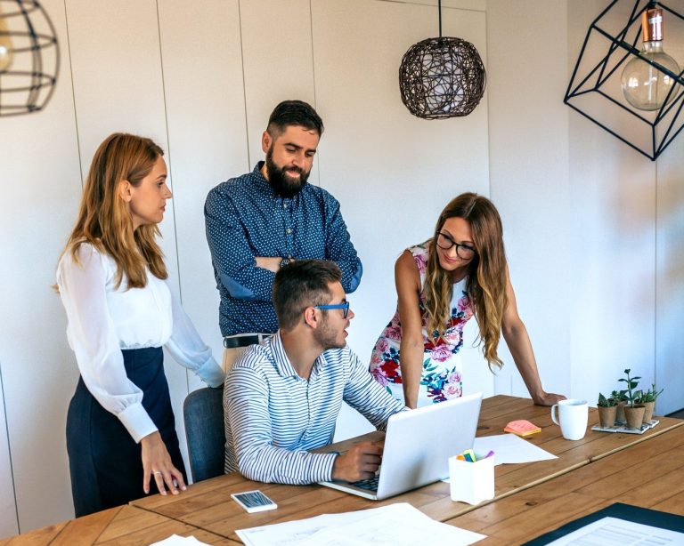 Business people in a meeting standing evaluating a trainee worker