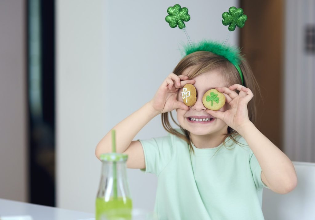 Cheerful girl with cookie having a fun