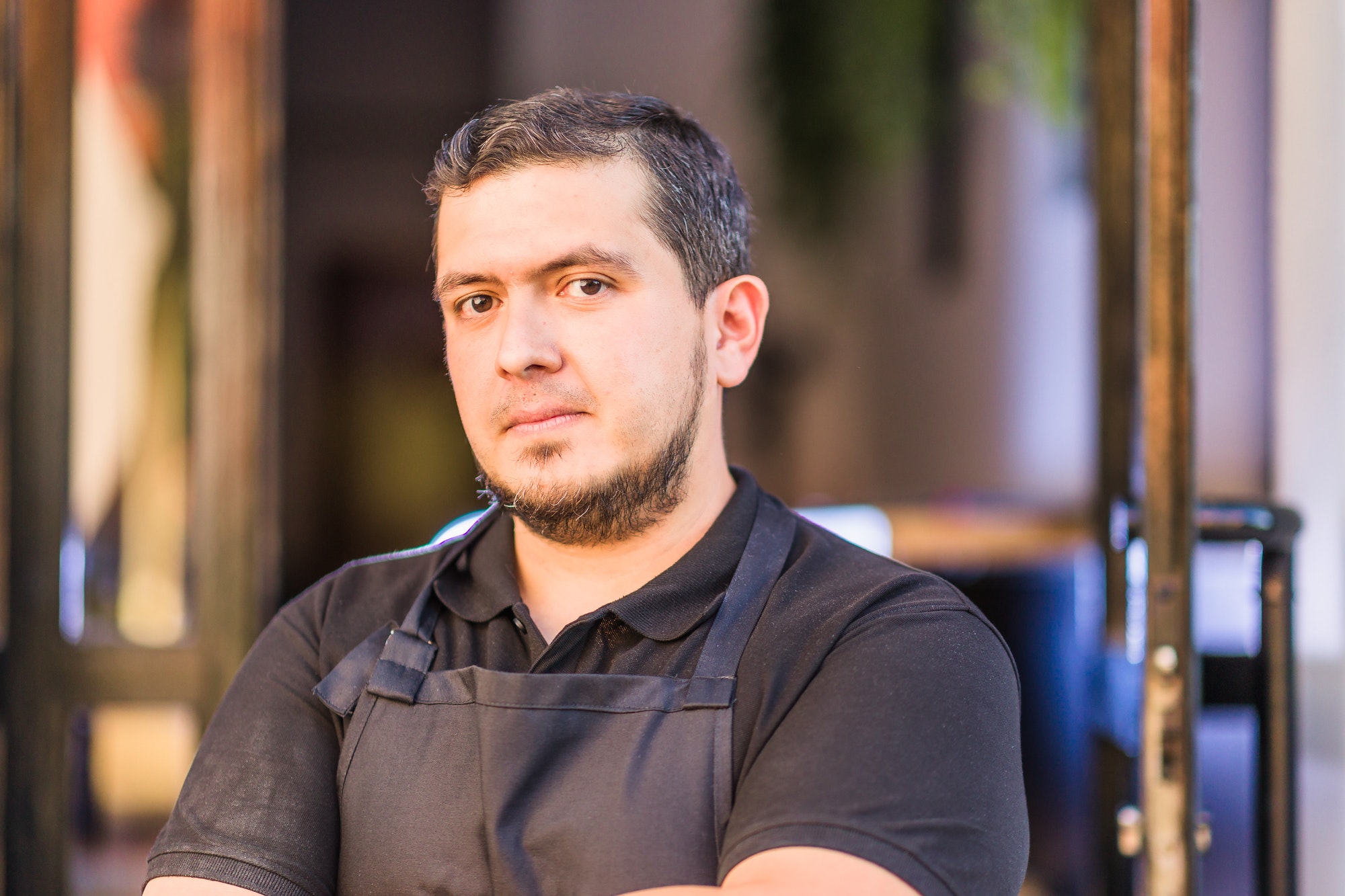 Latin mid chef entrepreneur with professional uniform. successful owner manager. venezuelan man