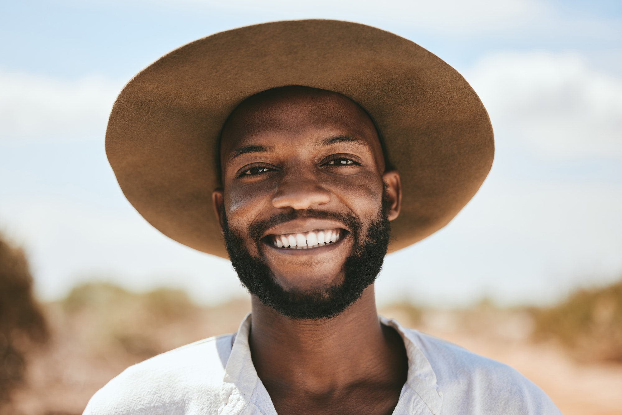 Portrait, black man smile and travel for holiday, vacation and on countryside outdoor. Happy face,