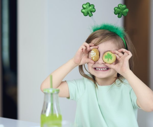 Cheerful girl with cookie having a fun