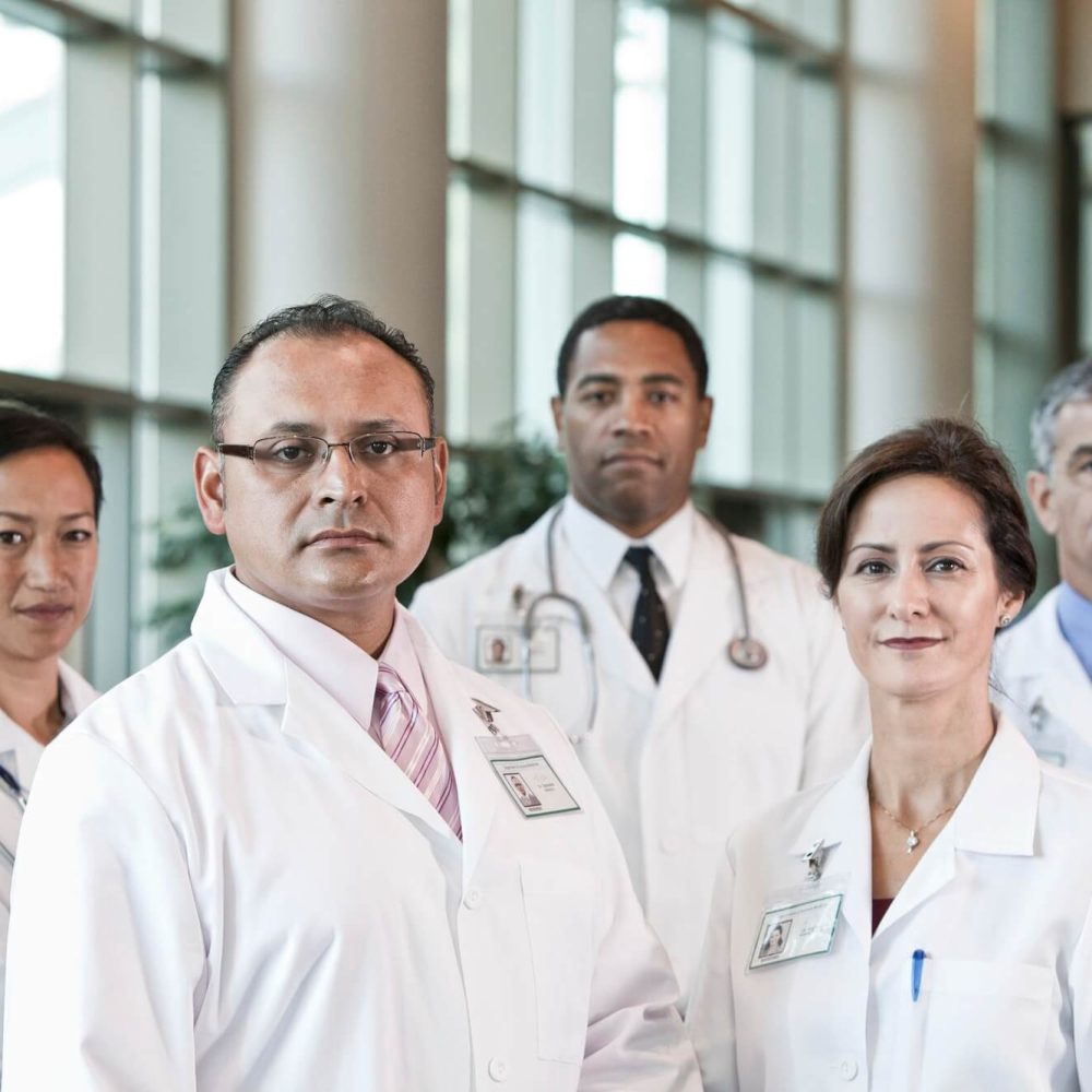 mixed-race-group-of-doctors-in-lab-coats- (1)